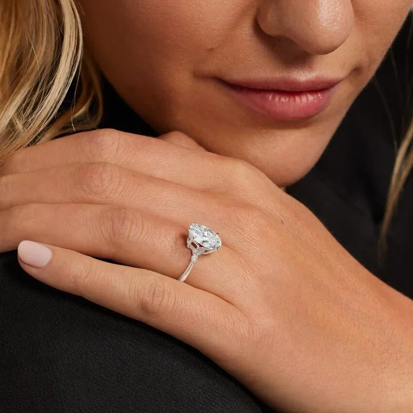 Diamond engagement ring in white gold seen close up on the hand
