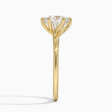 Delilah Twist Solitaire Engagement Ring with a Round cut diamond in yellow gold — profile view