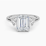 Luxe Floating Three Stone Diamond Engagement Ring with a Emerald cut diamond in white gold — top view