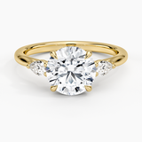 Floating Three Stone Pear Diamond Engagement Ring with a Round cut diamond in yellow gold — top view