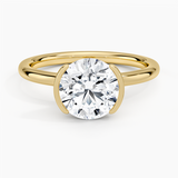 Annika Half Bezel Solitaire Engagement Ring with a Round cut diamond in yellow gold — top view