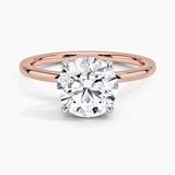 Adorned Mixed Metal Diamond Engagement Ring with a Round cut diamond in rose gold — top view