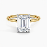 Adorned Mixed Metal Diamond Engagement Ring with a Emerald cut diamond in yellow gold — top view