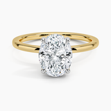 Adorned Mixed Metal Diamond Engagement Ring with a Oval cut diamond in yellow gold — top view