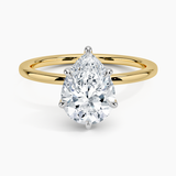 Adorned Mixed Metal Diamond Engagement Ring with a Pear cut diamond in yellow gold — top view