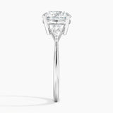 Luxe Cometa Three Stone Diamond Engagement Ring with a Round cut diamond in white gold — profile view