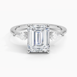 Luxe Cometa Three Stone Diamond Engagement Ring with a Emerald cut diamond in white gold — top view