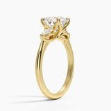 Fleur Three Stone Diamond Engagement Ring with a Round cut diamond in yellow gold — side view