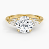 Fleur Three Stone Diamond Engagement Ring with a Round cut diamond in yellow gold — top view